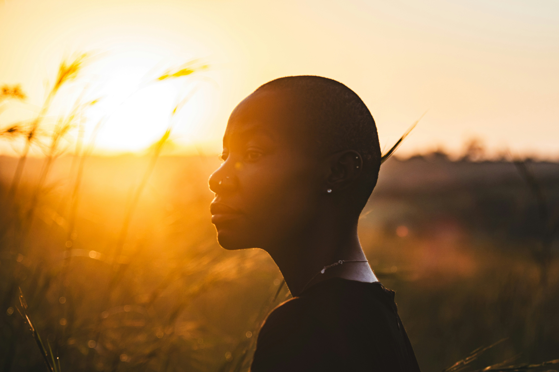 A hopeful young woman looking through a sunlit window, symbolizing renewed possibility in psychiatric care